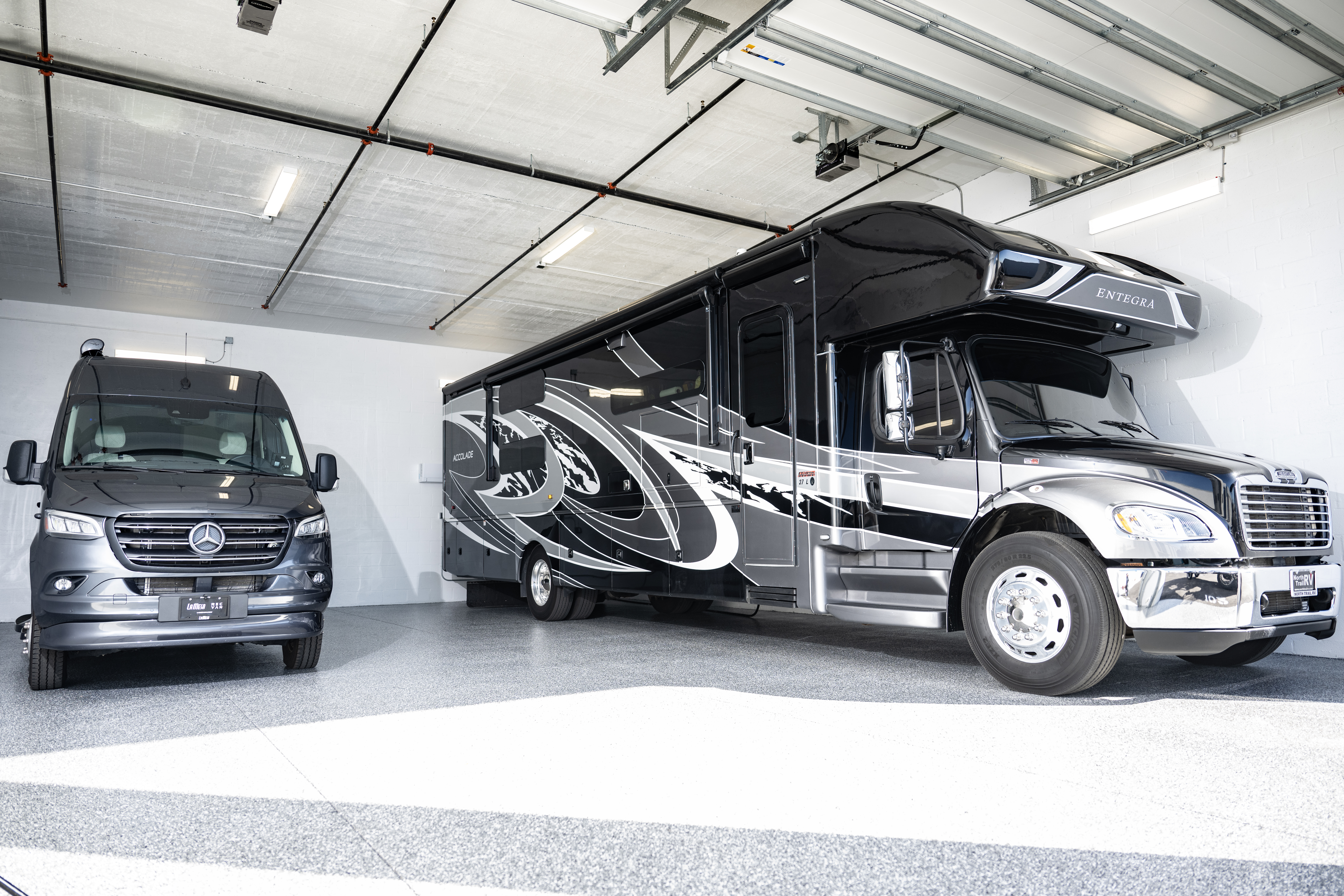 Large Class A motorhome and Mercedes Sprinter van parked side by side inside a clean, climate-controlled private storage unit at MetroMaxx RV & Boat Storage.